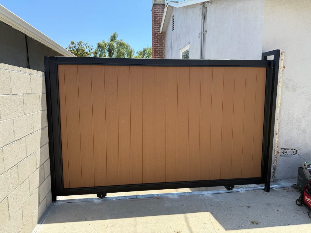 Sliding driveway gate in metal with composite infill